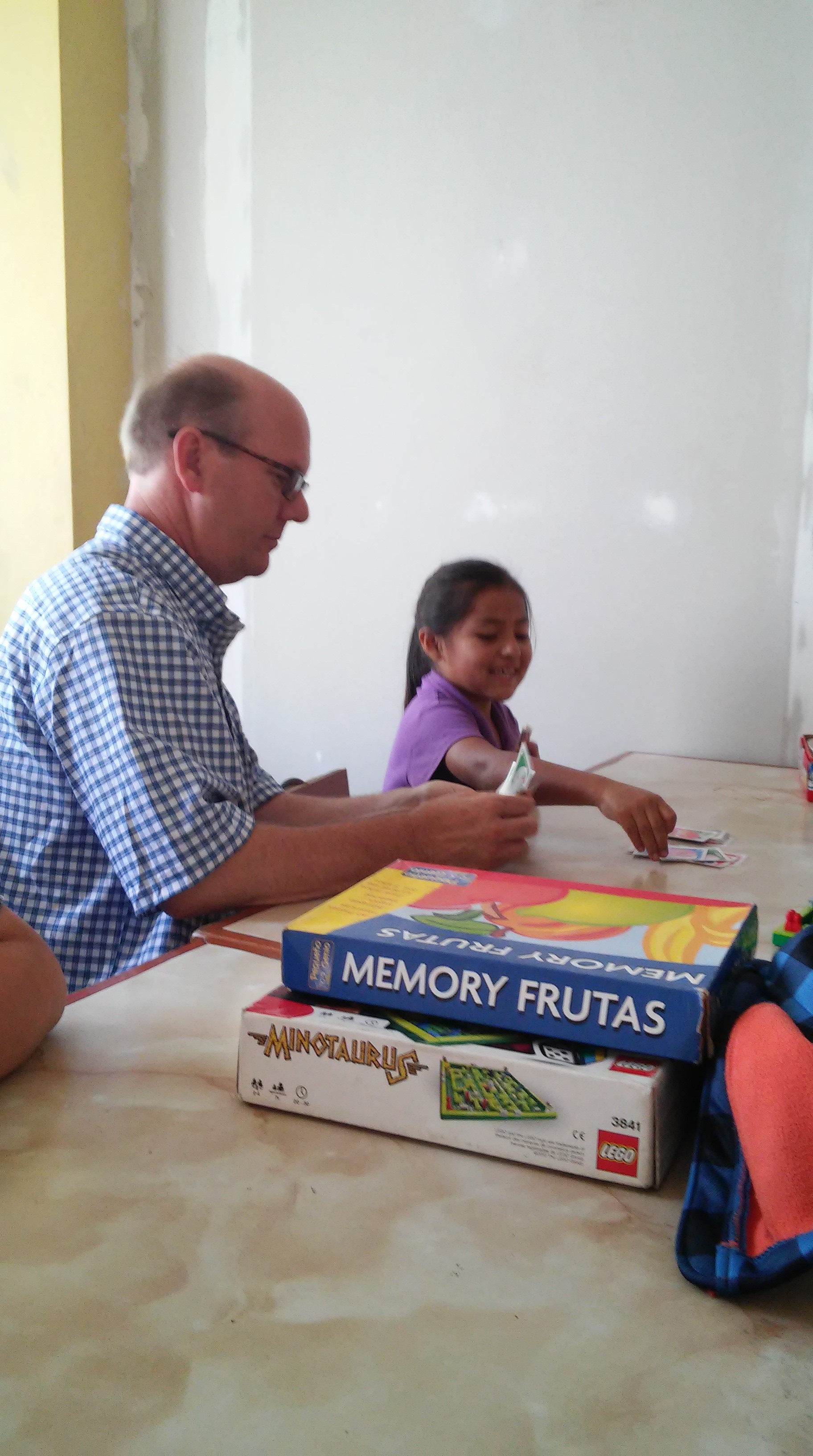 Professor playing card game Uno with a young child