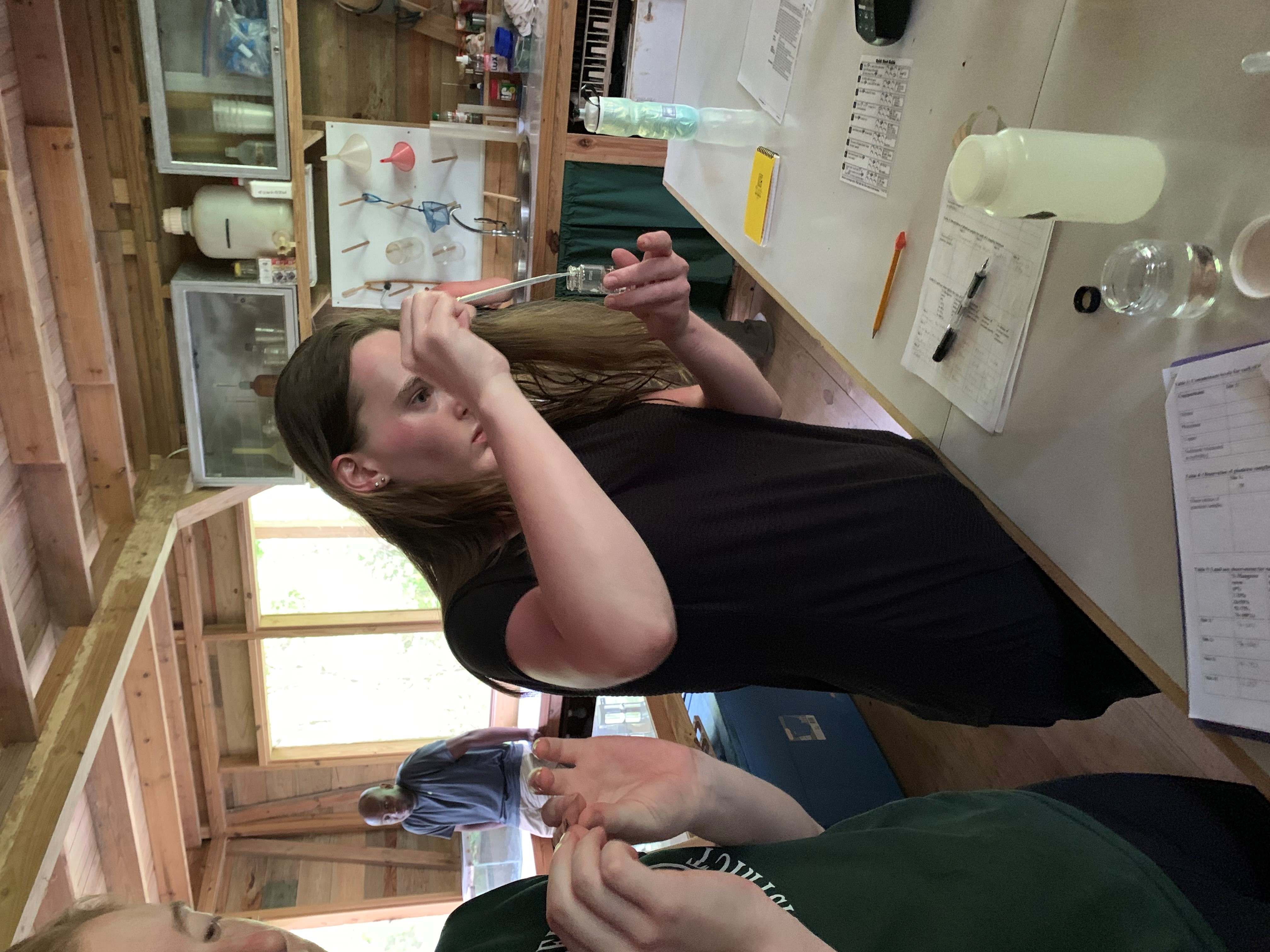 Young woman in the lab with scientific equiptment testing water