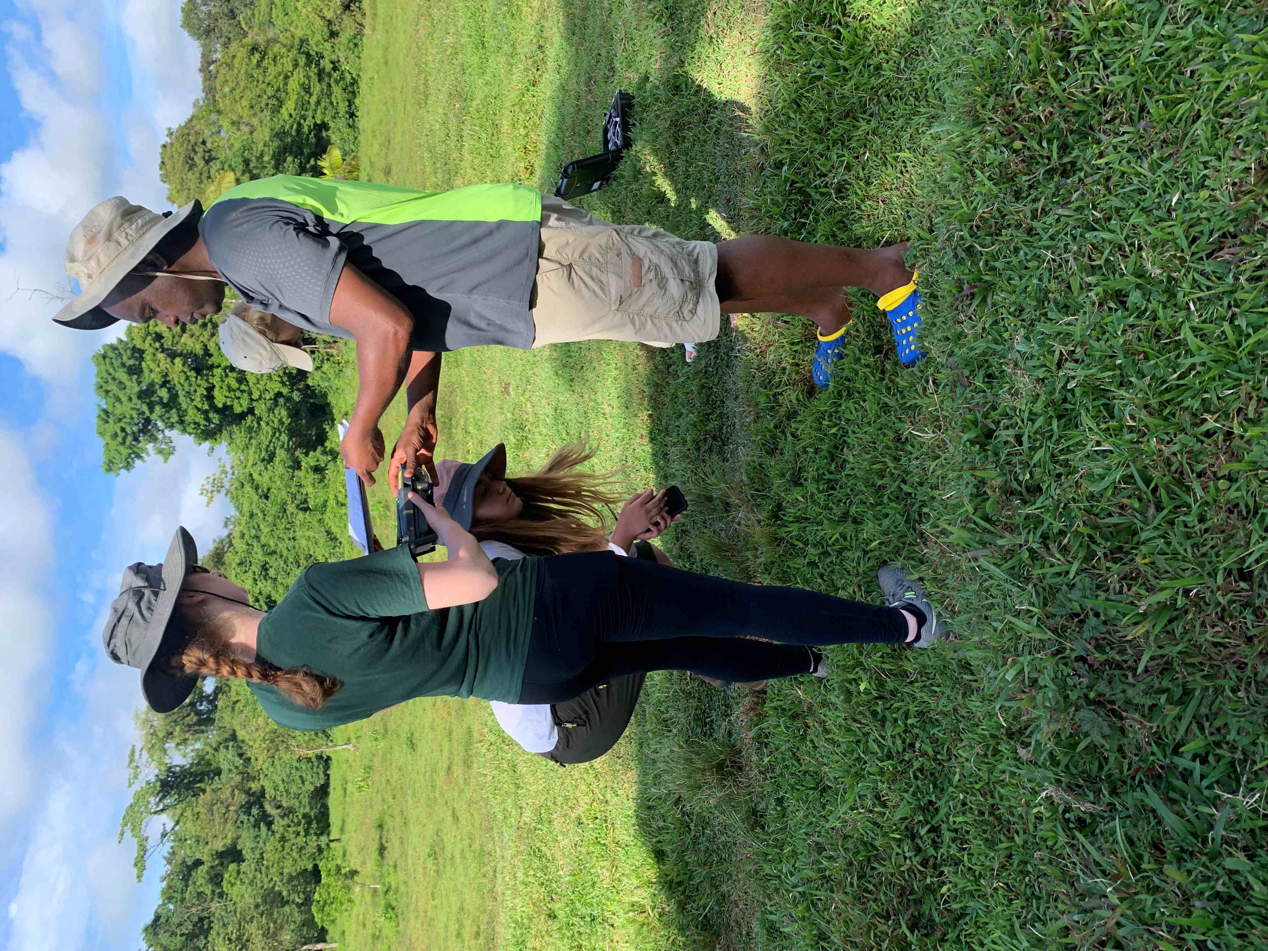 Harper professor and students being taught how to use a drone