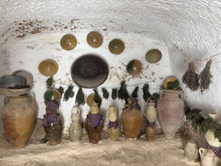 Kitchen items and herbs on the walls of an Amazigh cave dwelling