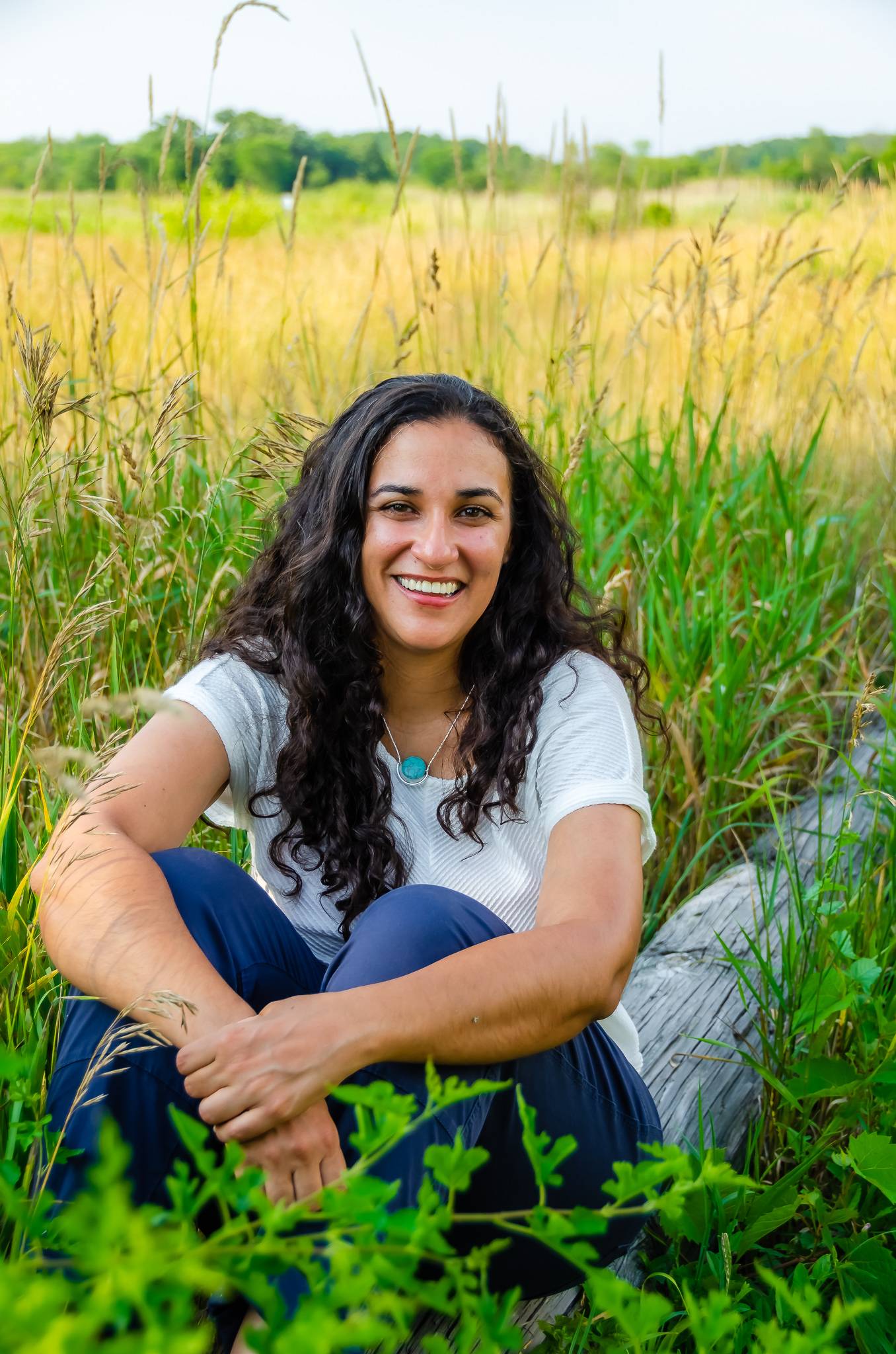 photo of Nellie sitting in a field and smiling