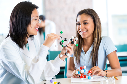 two women discussing chemistry