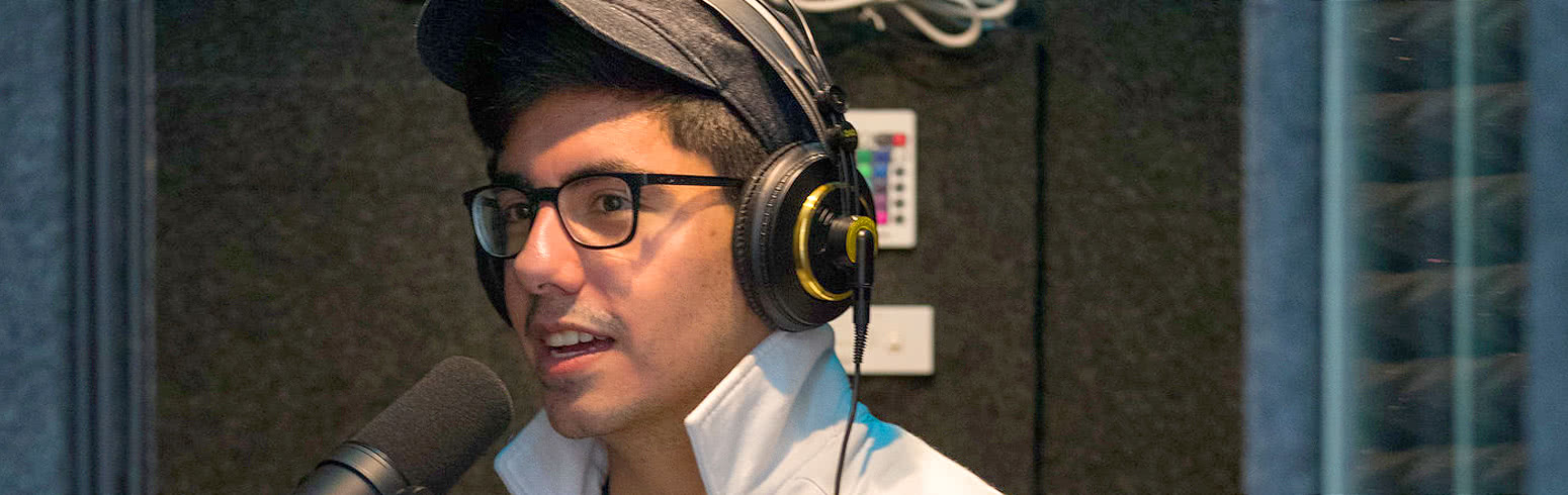 Harper Mass Communication degree student recording audio for the college radio station WHCM-FM 88.3 Hawk Radio on campus in the Chicago suburbs.
