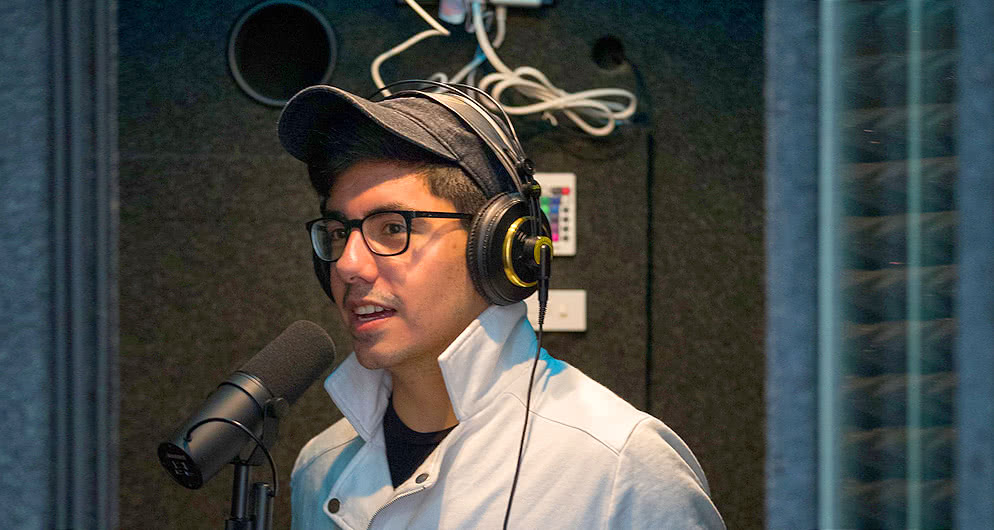 Harper Mass Communication degree student recording audio for the college radio station WHCM-FM 88.3 Hawk Radio on campus in the Chicago suburbs.