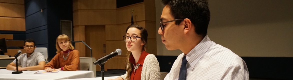 Students in the Harper College Speech and Debate team having a discussion in a lecture hall on campus in the Chicago suburbs.