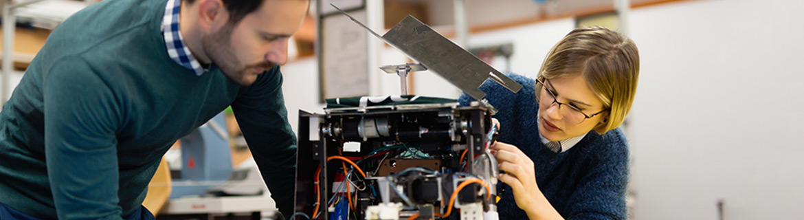 Man and woman examining electrical circuits