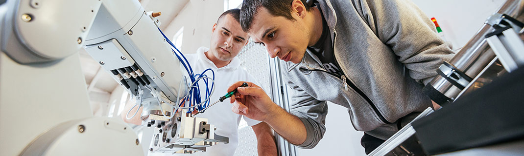 Man modifying wiring of mechanical circuit