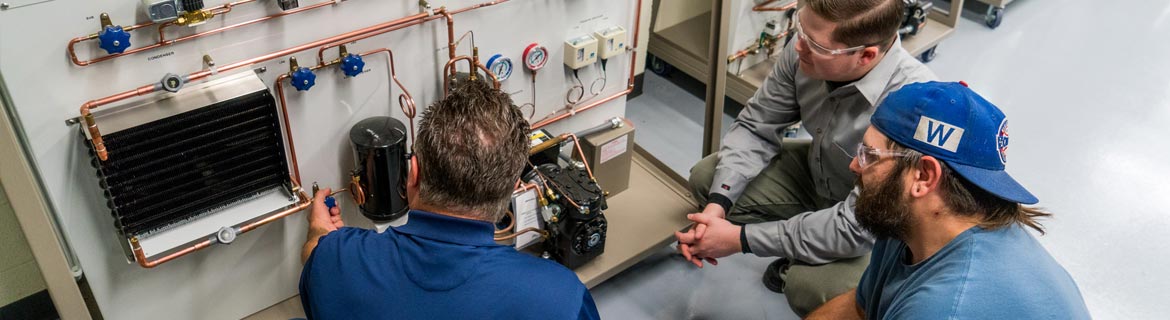 Men fixing air conditioning and refrigeration circuits