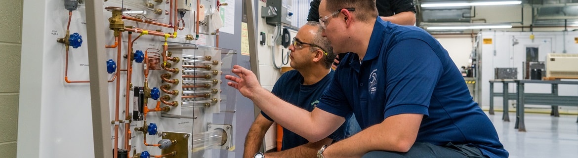 Men fixing refrigeration wiring