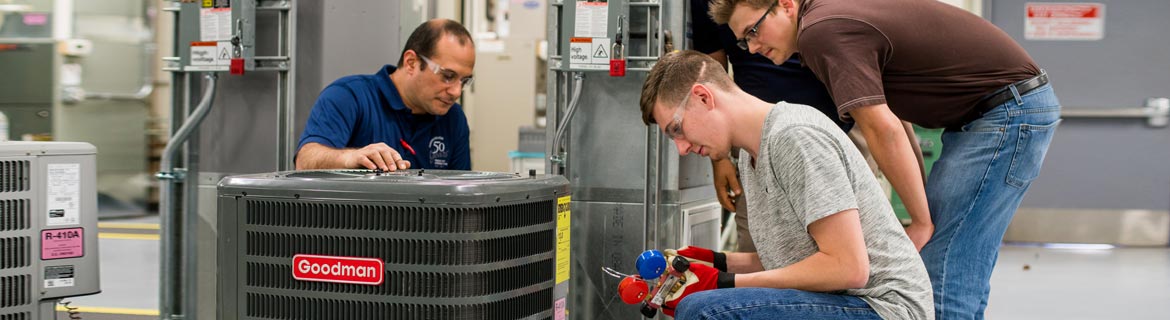 Men working on hardware and electrical machines