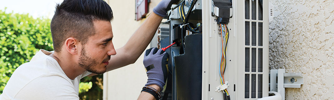 Man fixing wiring in machinery