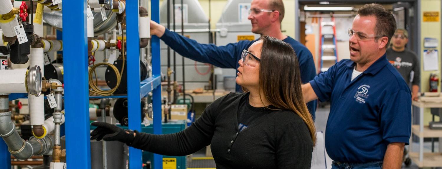 Harper College Maintenance Technology students repairing an HVAC system in the maintenance training workshop on campus in the Chicago suburbs.
