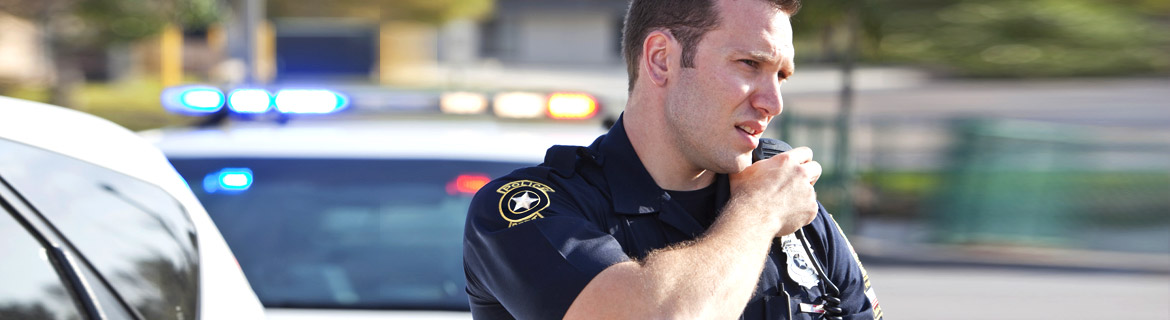 Police officer speaking into his walkie-talkie