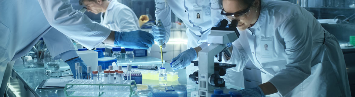 Biologist using microscope to view specimens