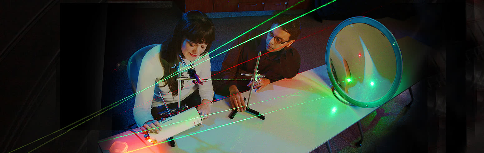 Researchers work in a greenhouse.