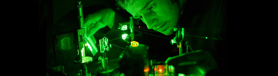 Physicist looking at specimens using equipment