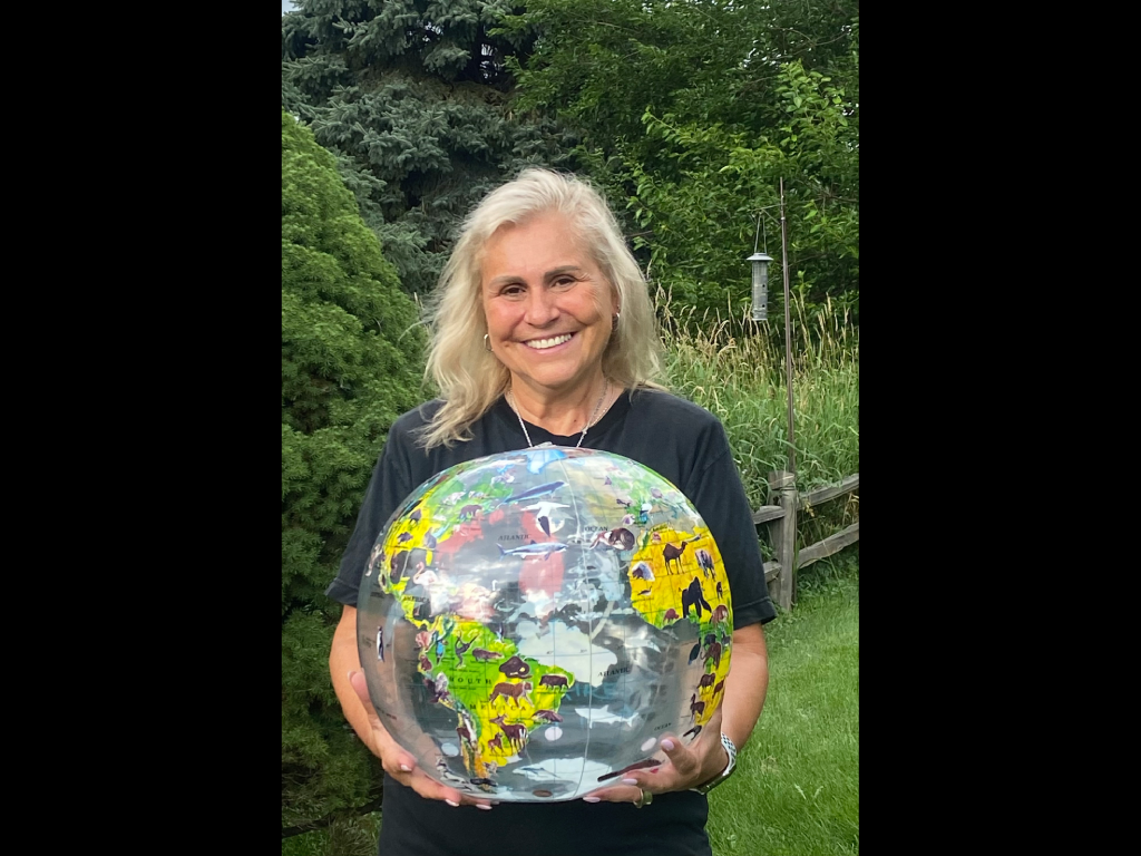 Harper College Geography Department Chair Veronica Mormino holding an inflatable globe.