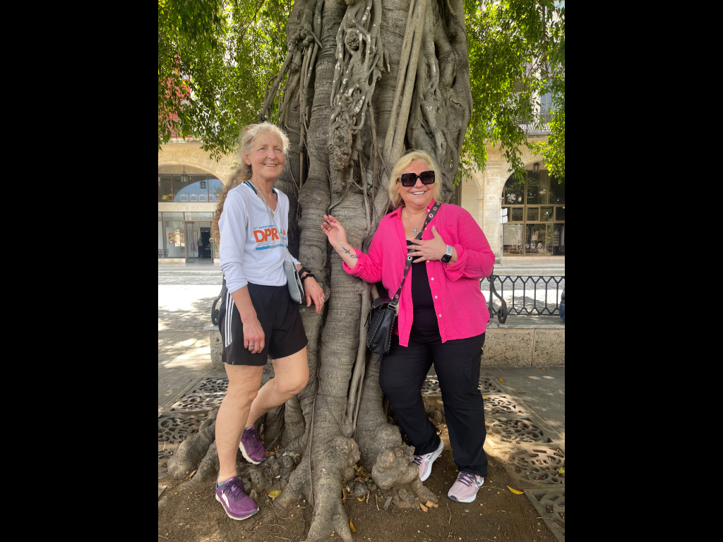 Geography Department Chair Veronica Mormino posing by a tree.