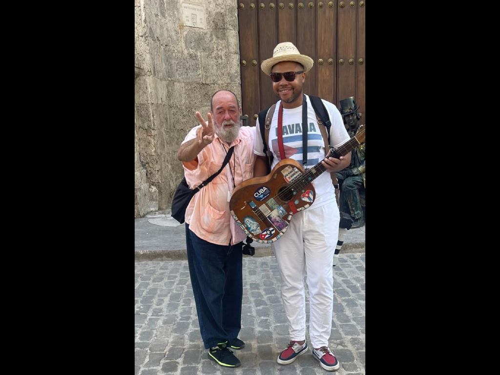 Harper Geography student posing with a local during the Cuba study abroad trip.