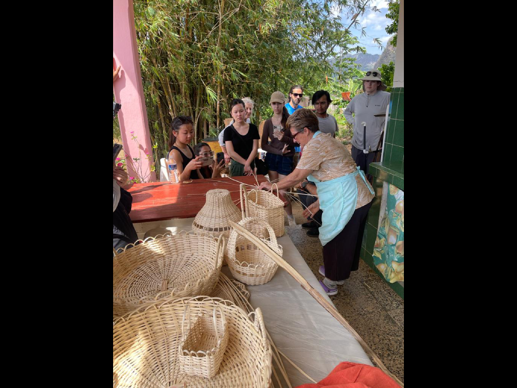 Harper College Geography students attend a basket weaving demonstration during a study abroad trip.