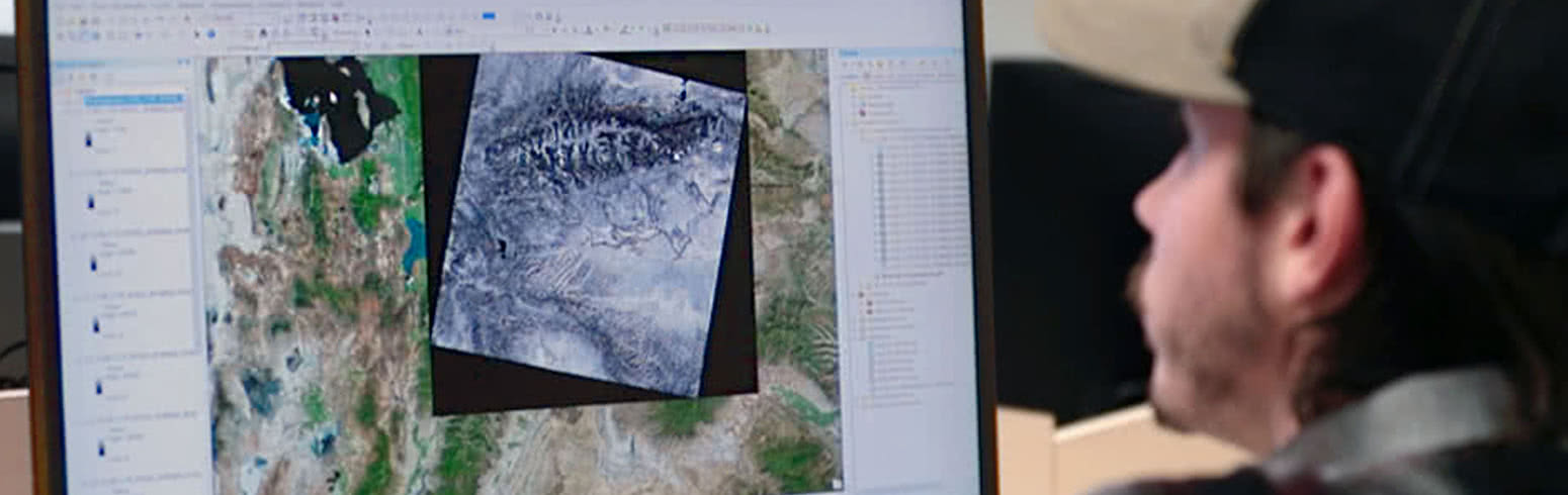 Harper College Geographic Information Systems student viewing a digital map with geographical data.