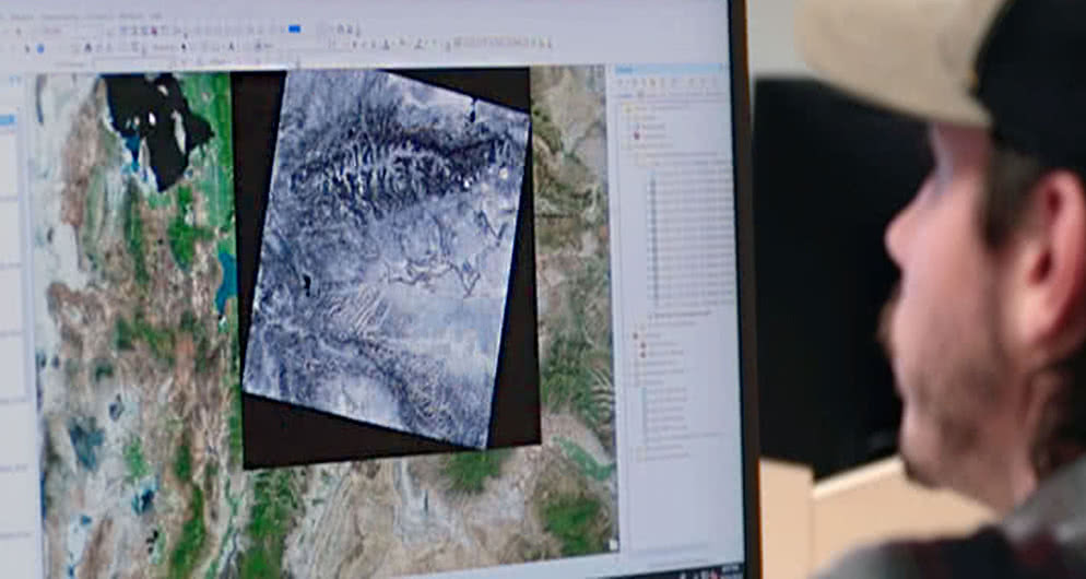 Harper College Geographic Information Systems student viewing a digital map with geographical data.