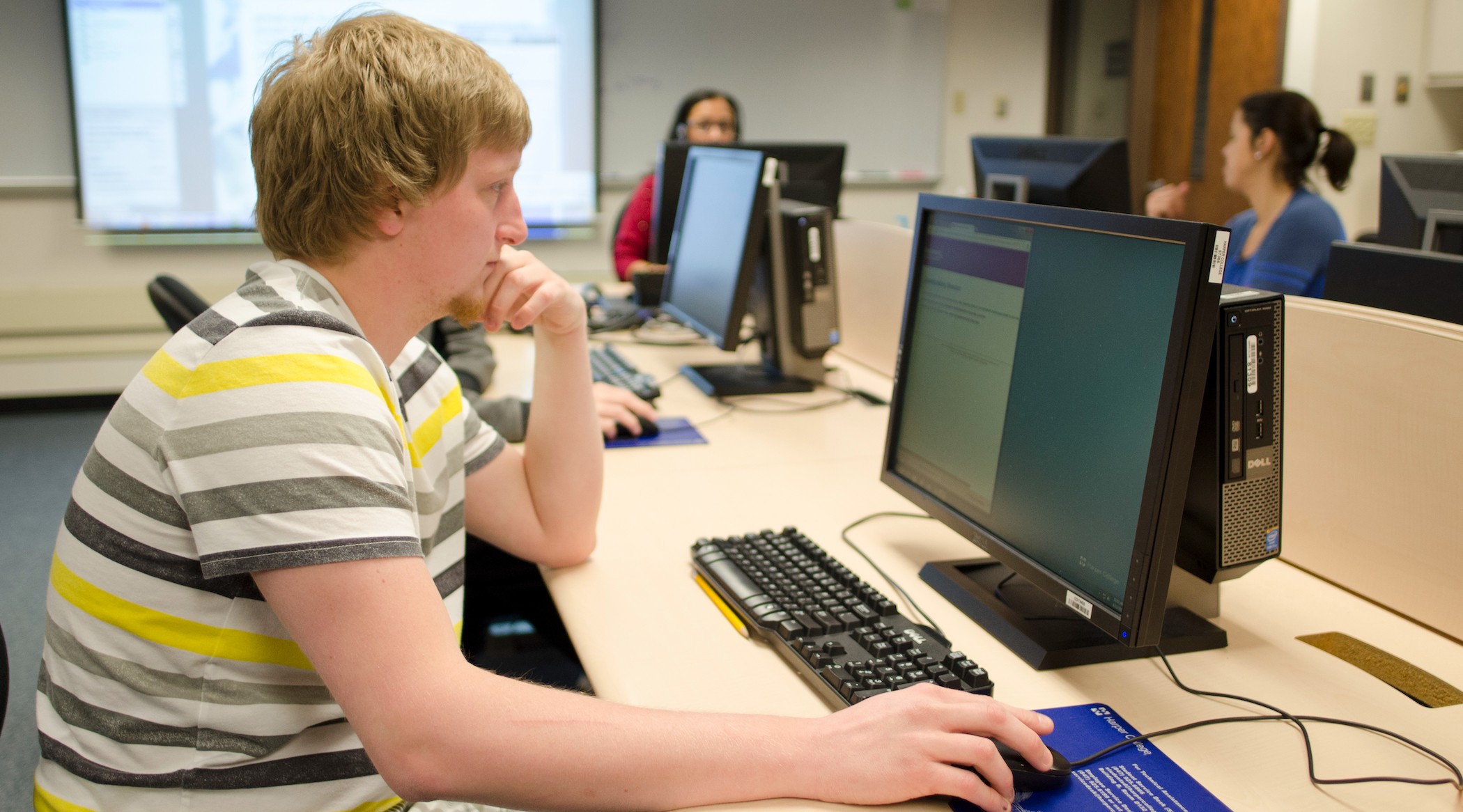 Computer Science associate degree students working on computers in a classroom at Harper College's campus near Chicago.