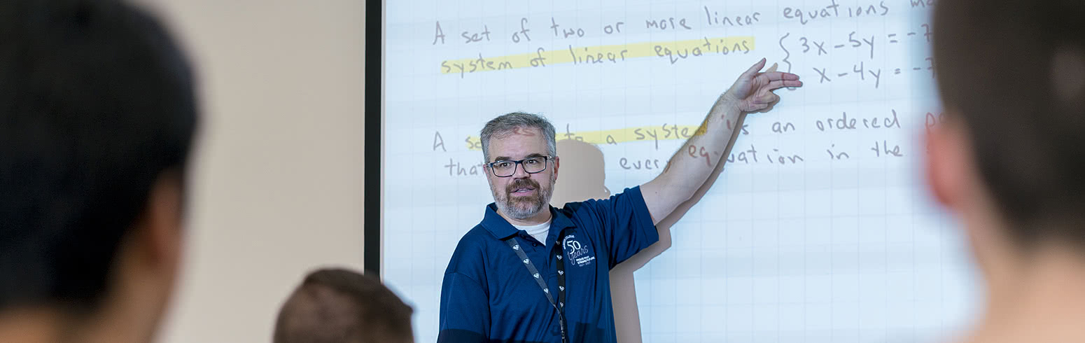 Harper College Math professor presenting a math lesson to a classroom of students.
