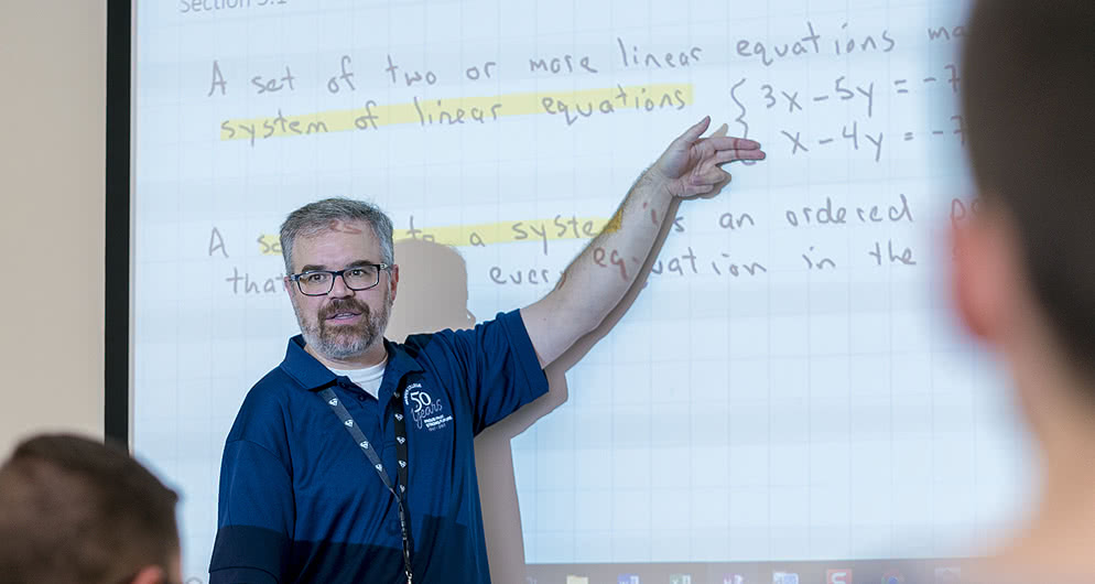 Harper College Math professor presenting a math lesson to a classroom of students.