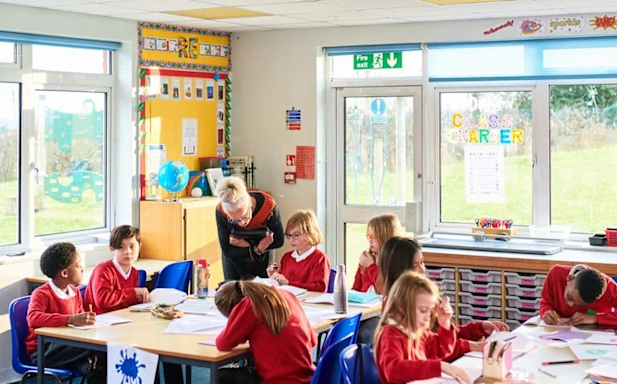A classroom full of young students being taught by a teacher in the apprenticeship program.