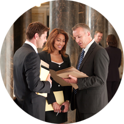 three people in business wear have a discussion in an office