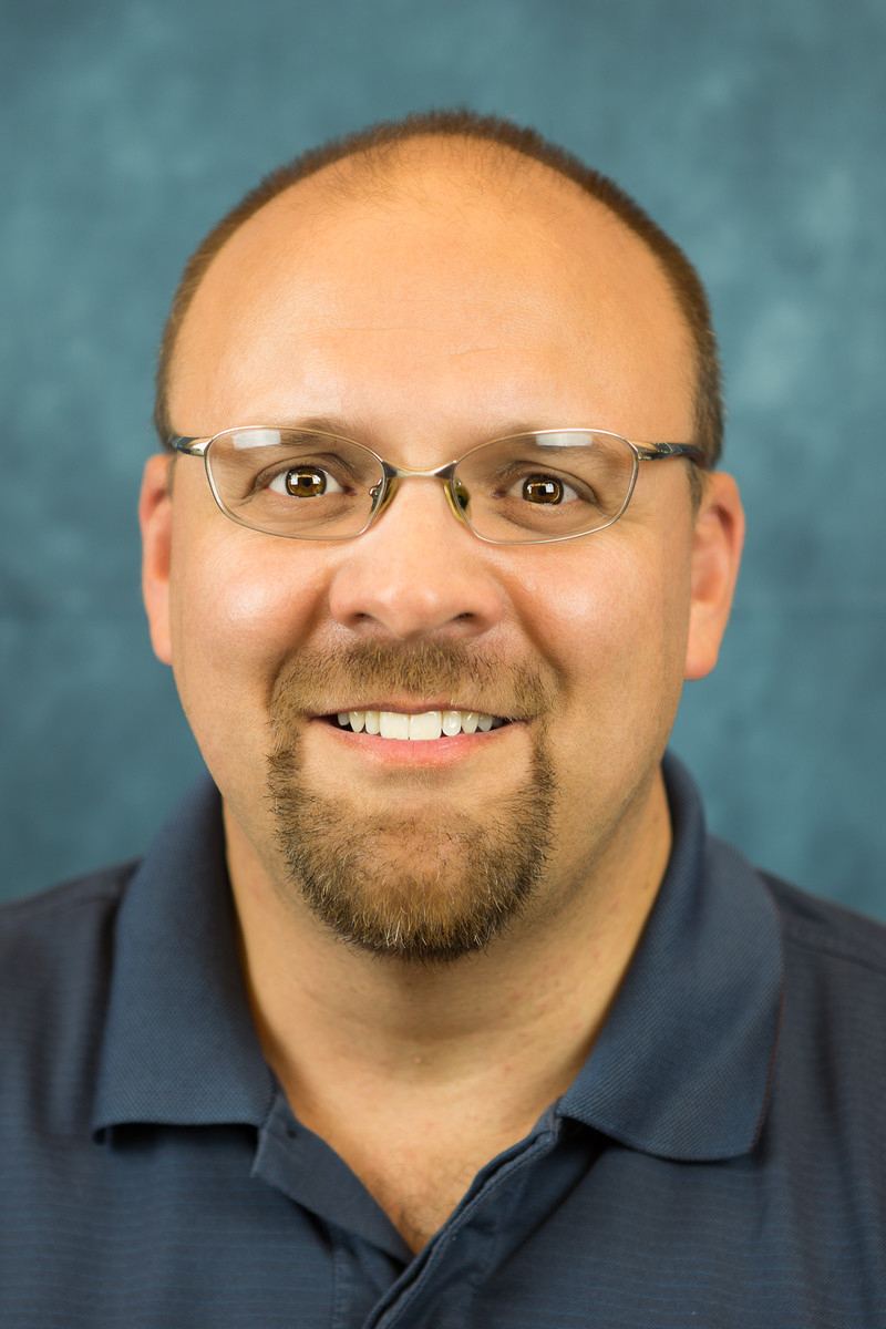 Headshot of Dan Rey smiling