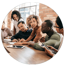Employees talk, sitting at a table