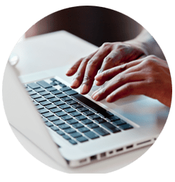 Closeup of hands typing on a laptop
