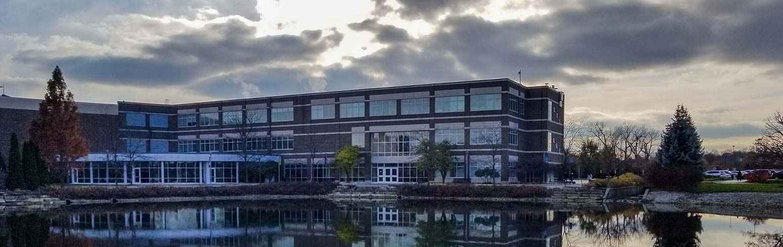 Wojcik Conference Center reflects in the lake.