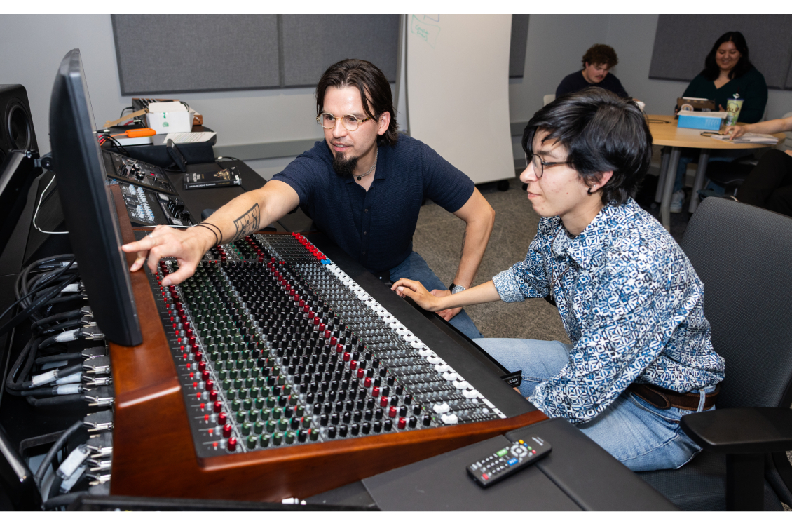 Harper music faculty member Edward Hamel assists a student with recording equipment