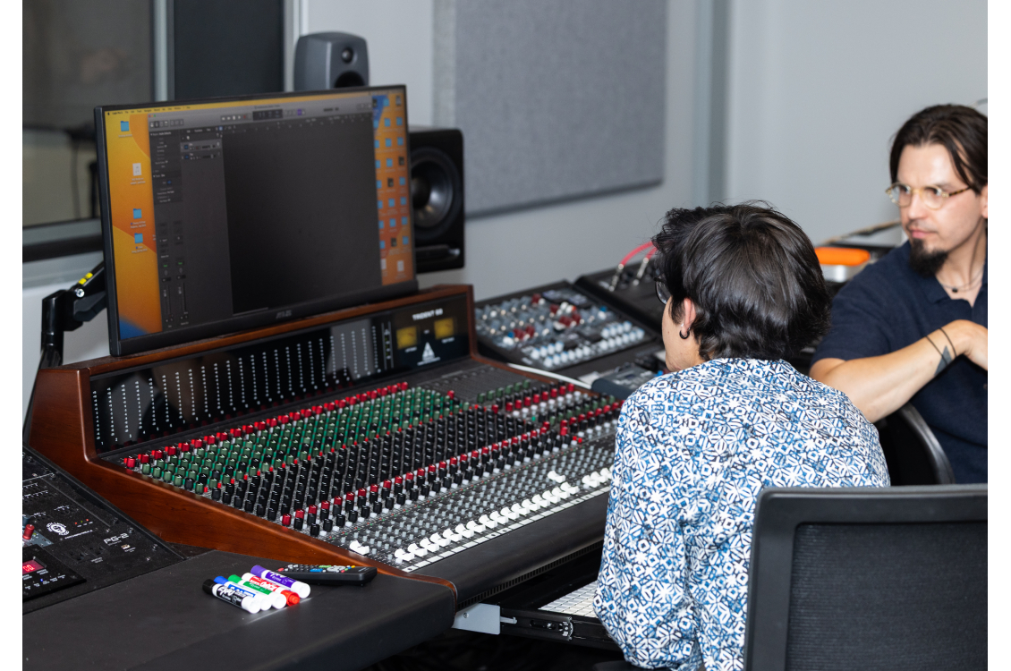 Harper music faculty member Edward Hamel assists a student with recording equipment