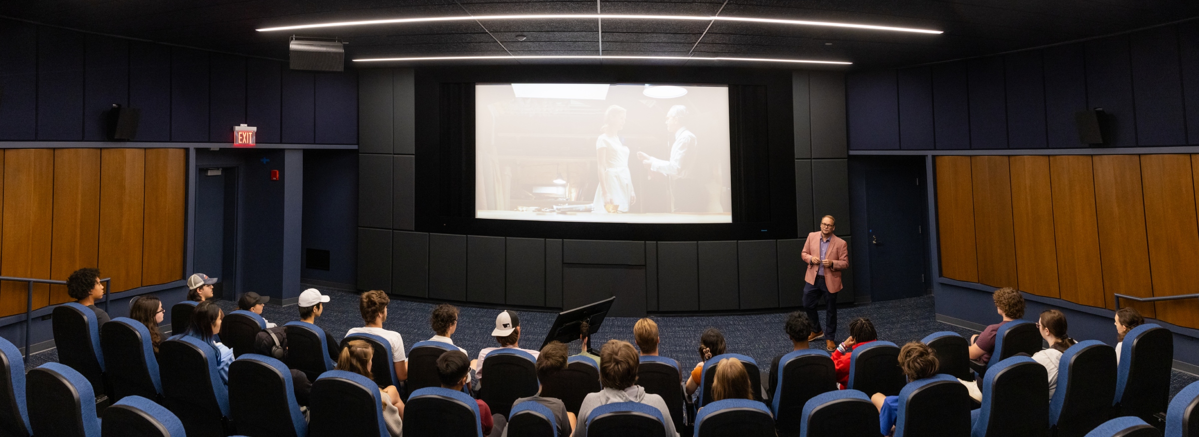 Students watching and analyzing a movie in the Film Lab at Harper College with their professor.