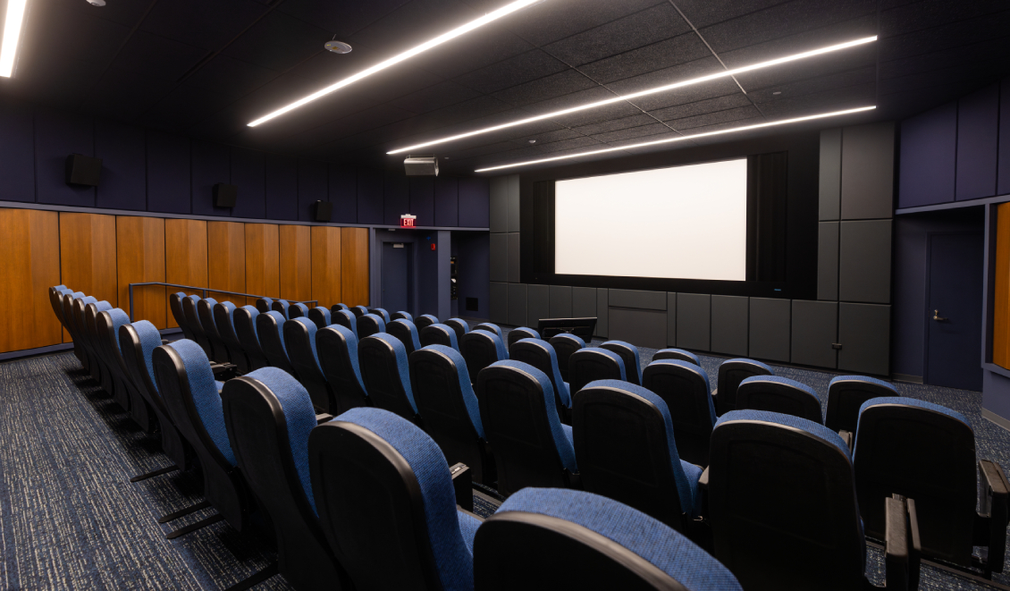 The Movie Screening Room/Film Lab at Harper College, viewed from a corner behind the empty seats that face the large projector screen
