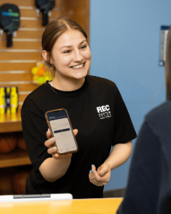 Campus Rec Employee Holding Phone