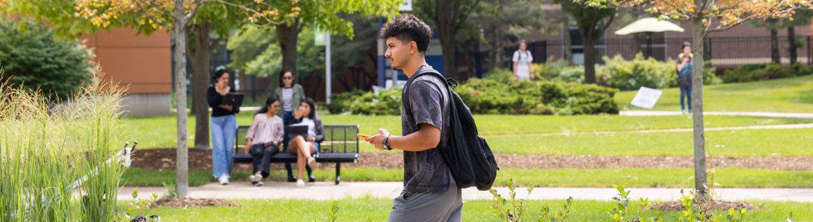 a student walking across the outside of harper campus