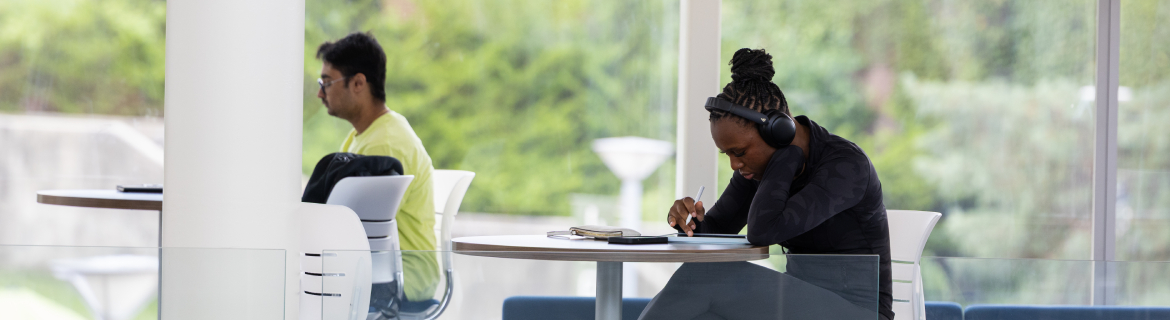 a harper college student studying at a tall table
