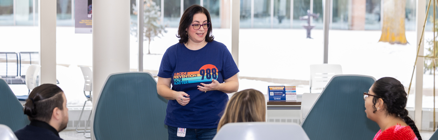a counselor standing and talking to a group