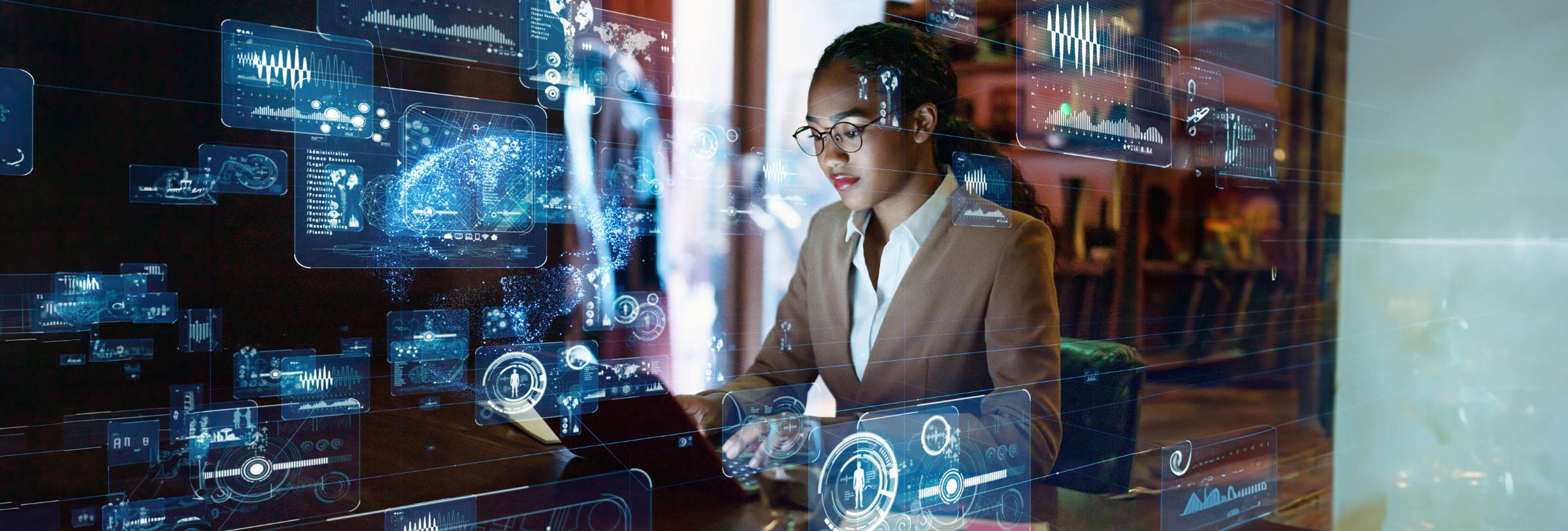 Woman in professional attire navigates computer systems in office setting