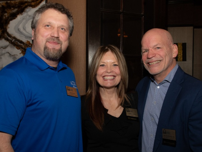 Three party attendees pose together