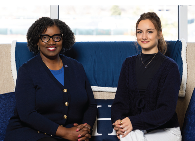 President Dr. Avis Proctor seated on a couch next to her scholarship recipient Carmryn