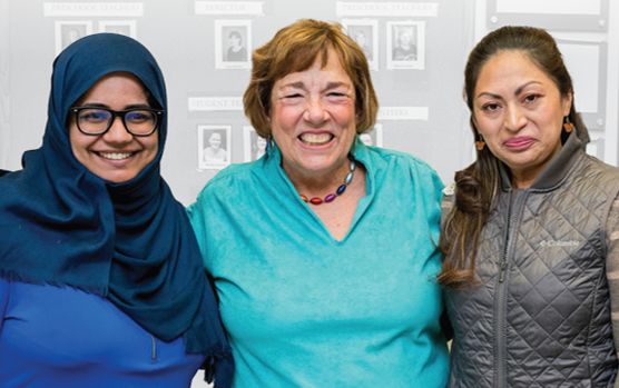 Jody Paine stands smiling between two of her scholarship recipients.
