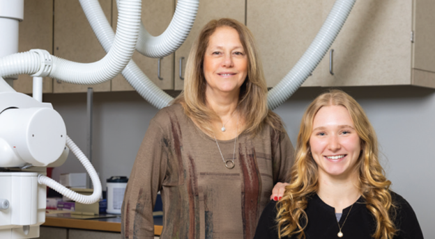 Leslye Smith and her scholarship recipient smiling in a Harper health career classroom