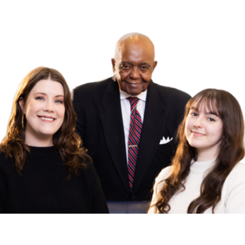 Reverend Brooks stands smiling between two scholarship recipients