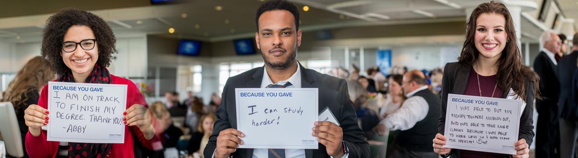 Scholarship Recipients Three students holding signs with their Because You Gave stories, for example: Because you Gave...I am on track to finish my degree